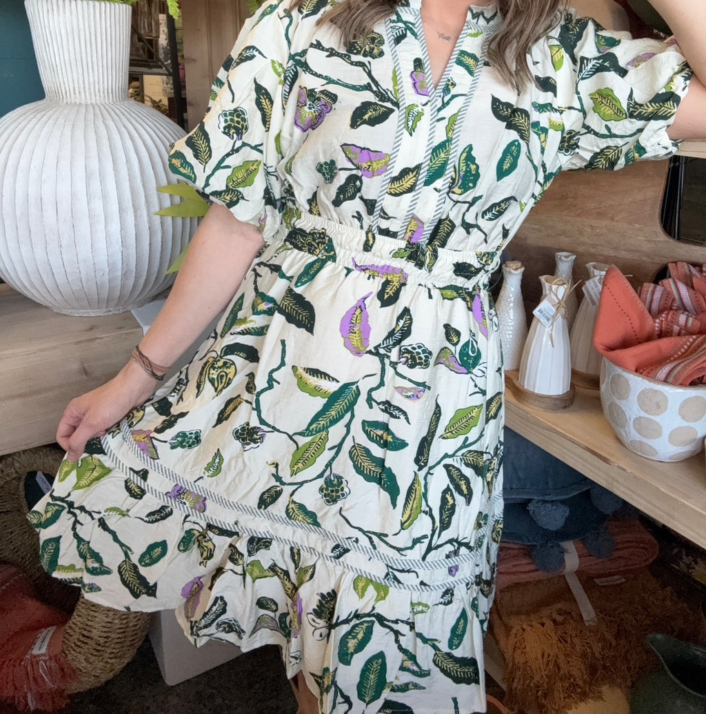 woman wearing woven botanical print mini dress with pockets