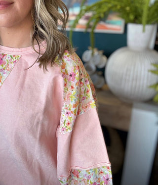 woman wearing blush boutique pullover with floral contrast sleeves